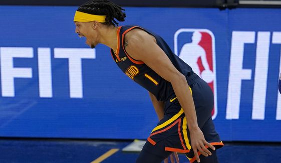 Golden State Warriors guard Damion Lee reacts after making a 3-point basket against the Philadelphia 76ers during the second half of an NBA basketball game in San Francisco, Tuesday, March 23, 2021. (AP Photo/Jeff Chiu)