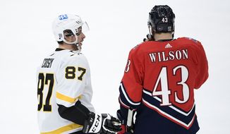 Pittsburgh Penguins center Sidney Crosby (87) talks with Washington Capitals right wing Tom Wilson (43) during the second period of an NHL hockey game, Tuesday, Feb. 23, 2021, in Washington. (AP Photo/Nick Wass) **FILE**