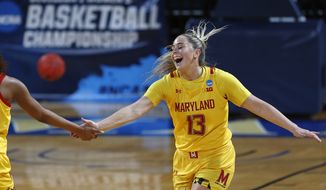 Maryland guard Faith Masonius (13) is congratulated after a basket during the first half of a college basketball game against Alabama in the second round of the women&#39;s NCAA tournament at the Greehey Arena in San Antonio on Wednesday, March 23, 2021. (AP Photo/Ronald Cortes)