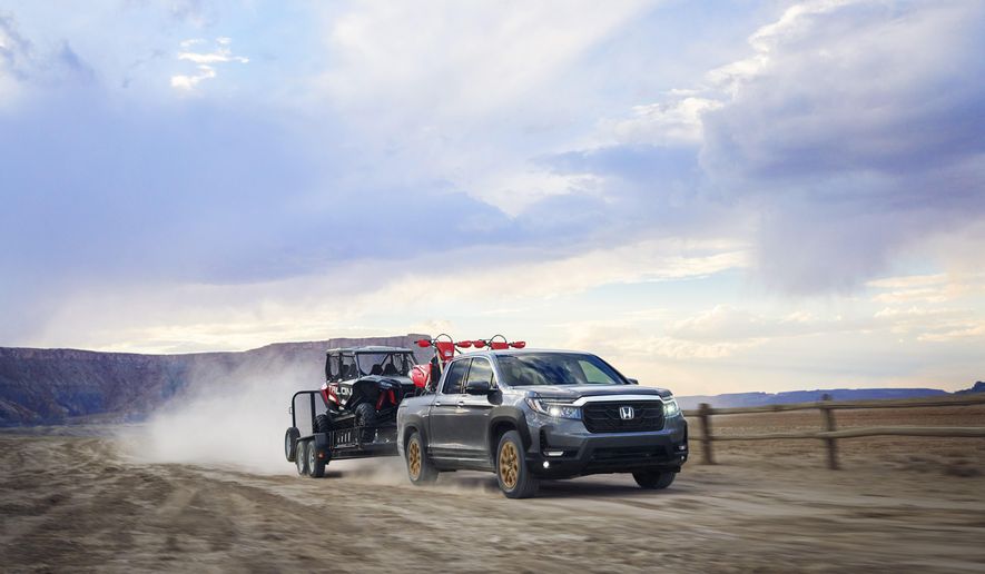 This photo provided by Honda shows the 2021 Honda Ridgeline, an example of a midsize pickup truck with respectable towing and hauling capability. Midsize trucks have decent towing and hauling capability, but you'll want to do some careful math before hooking up a trailer. (Blake Jorgenson/Courtesy of American Honda Motor Co. via AP)