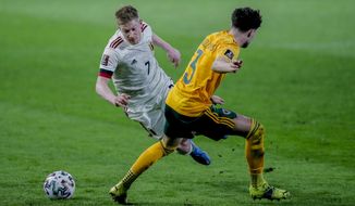 Belgium&#39;s Kevin De Bruyne, left, vies for the ball with Wales&#39; Neco Williams during a World Cup 2022 group E qualifying soccer match between Belgium and Wales at the King Power stadium in Leuven, Belgium, Wednesday, March 24, 2021. (AP Photo/Francisco Seco)