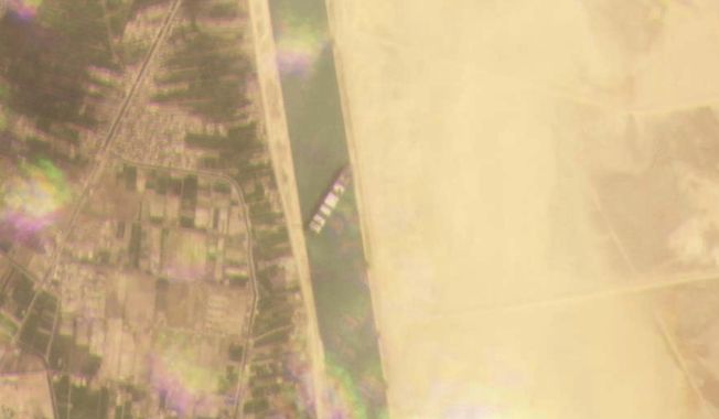 This satellite image from Planet Labs Inc. shows the cargo ship MV Ever Given stuck in the Suez Canal near Suez, Egypt, Tuesday, March 23, 2021. A cargo container ship that&#x27;s among the largest in the world has turned sideways and blocked all traffic in Egypt&#x27;s Suez Canal, officials said Wednesday, March 24, 2021, threatening to disrupt a global shipping system already strained by the coronavirus pandemic. (Planet Labs Inc. via AP)
