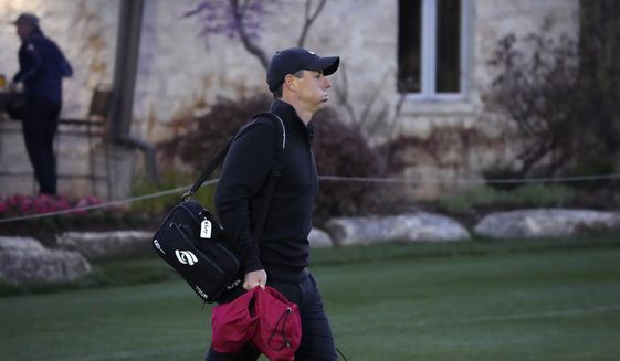 Rory McIlroy, of Northern Ireland, arrives on the driving range before the start of the first round match at the Dell Technologies Match Play Championship golf tournament Wednesday, March 24, 2021, in Austin, Texas. (AP Photo/David J. Phillip)