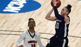 Northwestern guard Lindsey Pulliam (10) shoots over Louisville guard Kianna Smith (14) during the first half of a college basketball game in the second round of the women&#x27;s NCAA tournament at the Alamodome in San Antonio, Wednesday, March 24, 2021. (AP Photo/Charlie Riedel)