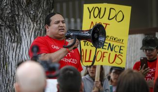FILE - In this June 12, 2019 file photo, Lakota activist Nick Tilsen speaks with the procession protesting against the Keystone XL pipeline outside the Andrew W. Bogue Federal Courthouse in Rapid City, S.D. When former President Donald Trump visited Mount Rushmore last year for a fireworks display, Tilsen saw an opportunity to advance the Land Back Movement, an effort to return to Native American tribes control of land they once held. Instead, he was among several protesters arrested and found himself facing several felonies. (Adam Fondren/Rapid City Journal via AP File)