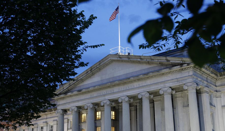 FILE - This Thursday, June 6, 2019, file photo shows the U.S. Treasury Department building at dusk, in Washington. The Treasury Department said Wednesday, March 24, 2021, that it has sent out another 37 million economic impact payments, bringing the total disbursed in the past two weeks to $325 billion. (AP Photo/Patrick Semansky, File)
