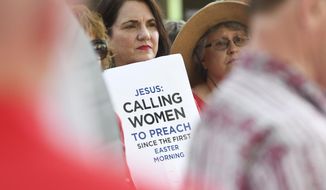 FILE - In this Tuesday, June 11, 2019 file photo, Janene Cates Putman of Athens, Tenn., holds a sign during a demonstration outside the Southern Baptist Convention&#39;s annual meeting in Birmingham, Ala. Among the millions of women belonging to churches of the Southern Baptist Convention, there are many who have questioned the faith’s gender-role doctrine and more recently urged a stronger response to disclosures of sexual abuse perpetrated by SBC clergy. (AP Photo/Julie Bennett)