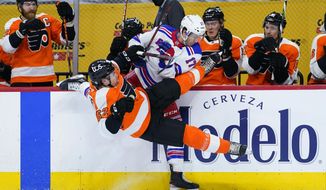 Philadelphia Flyers&#x27; Nicolas Aube-Kubel (62) and New York Rangers&#x27; Kevin Rooney (17) collide during the first period of an NHL hockey game, Thursday, March 25, 2021, in Philadelphia. (AP Photo/Matt Slocum)