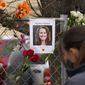 A photograph of Suzanne Fountain, one of the victims of a mass shooting at a King Soopers grocery store, hangs on the temporary fence around the store Wednesday, March 24, 2021, in Boulder, Colo. (AP Photo/David Zalubowski)