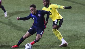 USA&#39;s Sergino Dest, left, duels for the ball with Jamaica&#39;s Kasey Palmer during the international friendly soccer match between USA and Jamaica at SC Wiener Neustadt stadium in Wiener Neustadt, Austria, Thursday, March 25, 2021. (AP Photo/Ronald Zak)