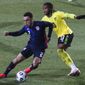 USA&#x27;s Sergino Dest, left, duels for the ball with Jamaica&#x27;s Kasey Palmer during the international friendly soccer match between USA and Jamaica at SC Wiener Neustadt stadium in Wiener Neustadt, Austria, Thursday, March 25, 2021. (AP Photo/Ronald Zak)