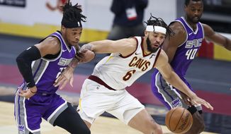 Cleveland Cavaliers&#39; JaVale McGee (6) works between Sacramento Kings&#39; Richaun Holmes (22) and Harrison Barnes (40) for the ball during the first half of an NBA basketball game Monday, March 22, 2021, in Cleveland. (AP Photo/Ron Schwane)