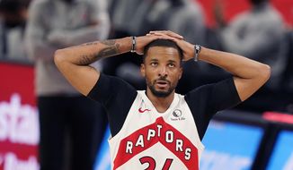 Toronto Raptors guard Norman Powell looks towards the scoreboard during the second half of an NBA basketball game against the Detroit Pistons, Wednesday, March 17, 2021, in Detroit. (AP Photo/Carlos Osorio)