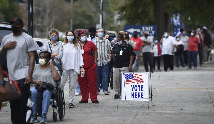 In this Oct. 12, 2020, file photo, people wait in line for early voting at the Bell Auditorium in Augusta, Ga. (Michael Holahan/The Augusta Chronicle via AP, File)
