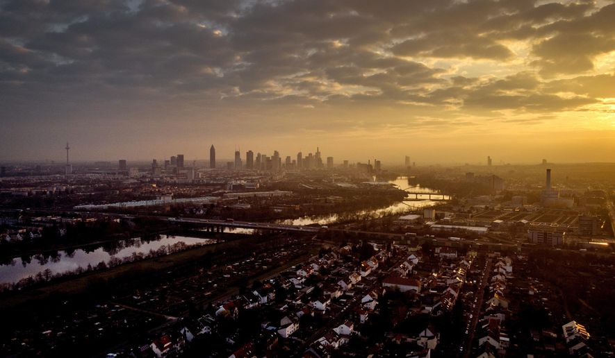 The buildings of the banking district are seen during sunrise in Frankfurt, Germany, Friday, March 26, 2021. (AP Photo/Michael Probst)