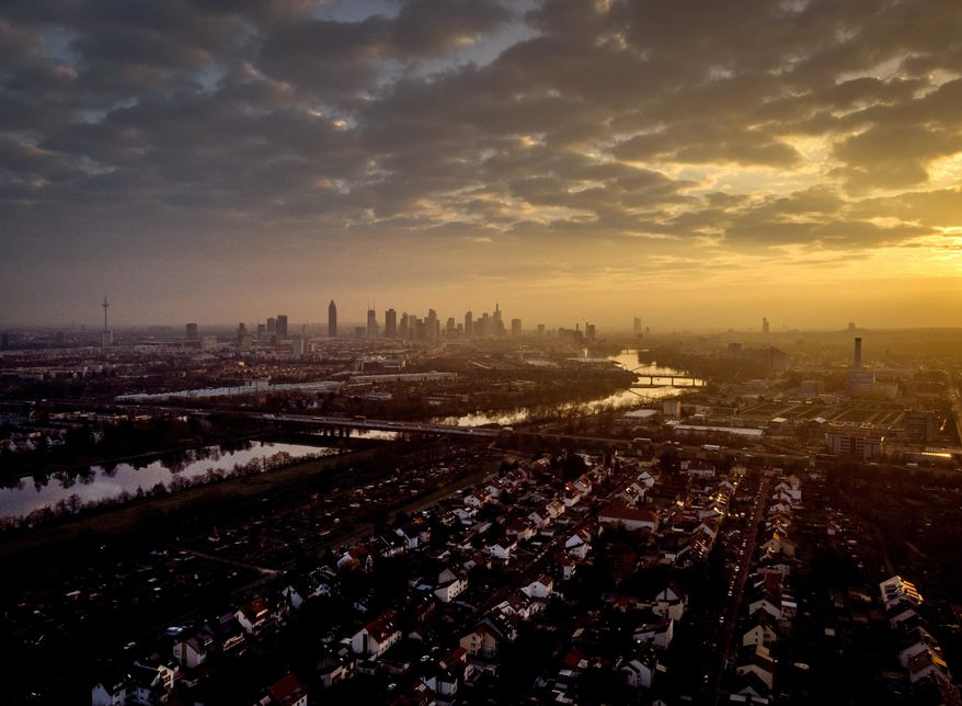 The buildings of the banking district are seen during sunrise in Frankfurt, Germany, Friday, March 26, 2021. (AP Photo/Michael Probst)