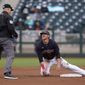 Cleveland Indians&#x27; Jake Bauers talks with umpire Nic Lentz, left, after being called out trying to steal second base during the fourth inning of a spring training baseball game against the San Francisco Giants Tuesday, March 23, 2021, in Goodyear, Ariz. (AP Photo/Ross D. Franklin)