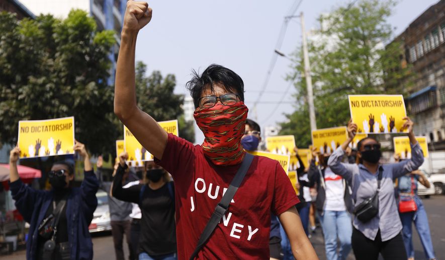 Anti-coup protesters gesture during a march in Yangon, Myanmar, Friday, March 26, 2021. Protesters against last month&#39;s military takeover in Myanmar returned to the streets in large numbers Thursday, a day after staging a &amp;quot;silence strike&amp;quot; in which people were urged to stay home and businesses to close for the day. (AP Photo)