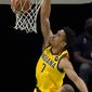 Indiana Pacers guard Malcolm Brogdon dunks during the first half of the team&#x27;s NBA basketball game against the Dallas Mavericks in Dallas, Friday, March 26, 2021. (AP Photo/Tony Gutierrez)