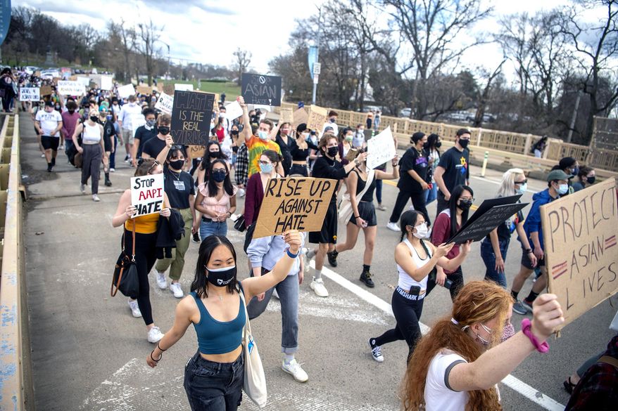 Attendees march from Pittsburgh's Flagstaff Hill to Schenley Plaza during the "PGH Rally for Solidarity" event to protest recent acts of violence towards Asian Americans, Wednesday, March 24, 2021, in the Oakland neighborhood of Pittsburgh. The rally was organized by the East Coast Asian American Student Union (ECAASU) and the Asian Pacific American Labor Alliance (APALA). (Alexandra Wimley/Pittsburgh Post-Gazette via AP)