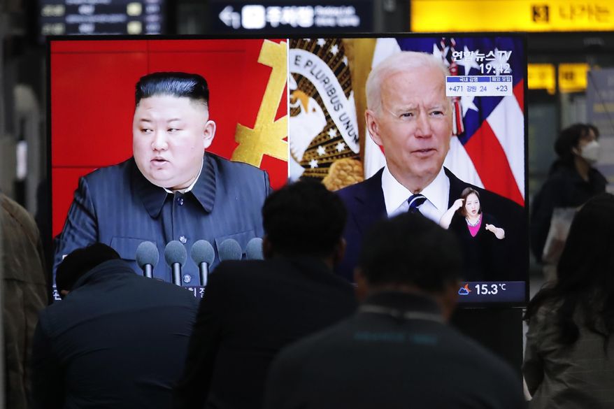 Commuters watch a TV showing a file image of North Korean leader Kim Jong Un and U.S. President Joe Biden during a news program at the Suseo Railway Station in Seoul, South Korea, Friday. March 26, 2021. North Korea on Friday confirmed it had tested a new guided missile, as Biden warned of consequences if Pyongyang escalates tensions amid stalled nuclear negotiations. (AP Photo/Ahn Young-joon)