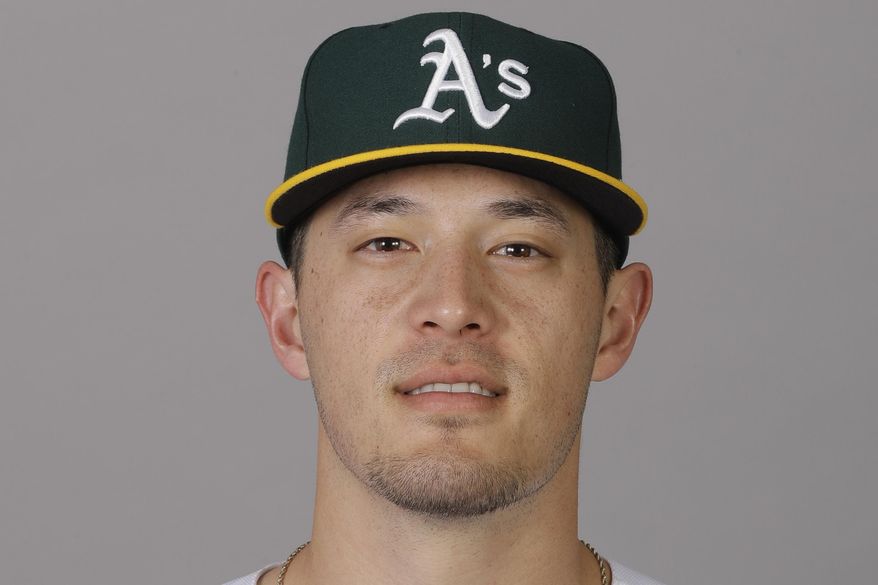 FILE - This is a 2020 file photo showing Collin Theroux of the Oakland Athletics baseball team. Following a year without a season due to the coronavirus pandemic, thousands of minor league players are finally returning to work. Many haven't played in a game since 2019, and players found creative ways to stay in shape and stay sharp. A’s catcher Collin Theroux focused on explosiveness. Among his workouts — venturing into the parking lot of his girlfriend's apartment complex and jumping on benches, electrical units or whatever else he could find. “Everybody was just embracing the weird at that point,” Theroux said. (AP Photo/Darron Cummings, File)