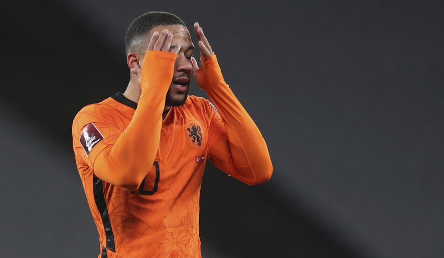 Netherlands' Memphis Depay reacts after a missed scoring opportunity during the World Cup 2022 group G qualifying soccer match between Turkey and Netherlands at the Ataturk Olimpiyat Stadium in Istanbul, Turkey, Wednesday, March 24, 2021. (Tolga Bozoglu/Pool Photo via AP)