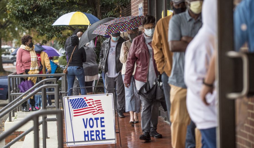 People wait in line on the first day of advance voting for Georgia&#39;s Senate runoff election at the Bell Auditorium in Augusta, Ga. (Michael Holahan/The Augusta Chronicle via AP, File)