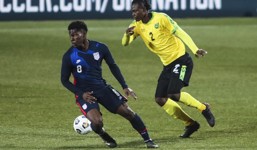 USA&#39;s Yunus Musah, left, duels for the ball with Jamaica&#39;s Chavany Willis during the international friendly soccer match between USA and Jamaica at SC Wiener Neustadt stadium in Wiener Neustadt, Austria, Thursday, March 25, 2021. (AP Photo/Ronald Zak)
