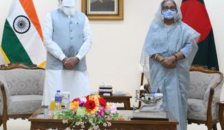 In this photo provided by Prime Minister of India Narendra Modi&#39;s twitter handle, Indian Prime Minister Narendra Modi and Bangladesh&#39;s Prime Minister Sheikh Hasina stands for a photograph in Dhaka, Bangladesh, Friday, March 26, 2021. Modi on Saturday concluded his two-day official visit to Bangladesh amid both violent protests and enthusiasm that the bilateral relations between the two neighbors would continue to grow. (Prime Minister of India Narendra Modi&#39;s twitter handle via AP Photo)