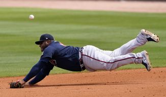 Atlanta Braves first baseman Pablo Sandoval can&#39;t reach a ball hit for a single by Tampa Bay Rays&#39; Willy Adames in the fifth inning of a spring training baseball game Sunday, March 21, 2021, in Port Charlotte, Fla. (AP Photo/John Bazemore)