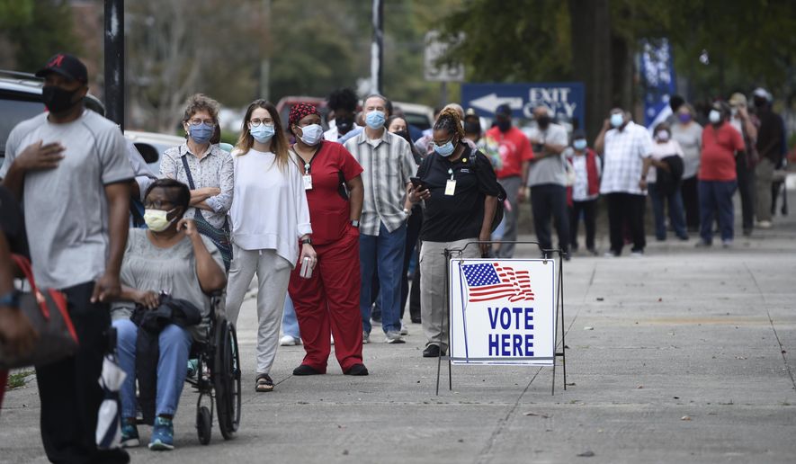 In this Oct. 12, 2020, file photo, people wait in line for early voting at the Bell Auditorium in Augusta, Ga. (Michael Holahan/The Augusta Chronicle via AP, File)  ** FILE **