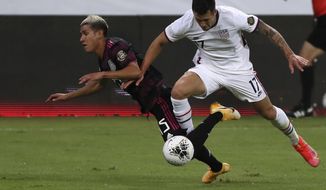 Mexico&#39;s Uriel Antuna, left, and United States&#39; Aaron Herrera fight for the ball during a Concacaf Men&#39;s Olympic Qualifying championship soccer match in Guadalajara, Mexico, Wednesday, March 24, 2021. (AP Photo/Fernando Llano)