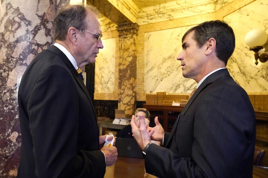 Lt. Gov. Delbert Hosemann, left, confers with Senate Appropriations Committee Chairman Briggs Hopson, R-Vicksburg, in Senate Chambers at the Capitol in Jackson, Miss., Wednesday, March 24, 2021. Lawmakers in both chambers are acting on extensive calendars of proposed legislation as they attempt to get ahead of deadline dates in an effort to finish this session earlier than its scheduled 90-days. (AP Photo/Rogelio V. Solis)