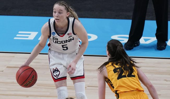 UConn guard Paige Bueckers (5) works the ball past Iowa guard Caitlin Clark (22) during the first half of a college basketball game in the Sweet Sixteen round of the women&#x27;s NCAA tournament at the Alamodome in San Antonio, Saturday, March 27, 2021. (AP Photo/Eric Gay)