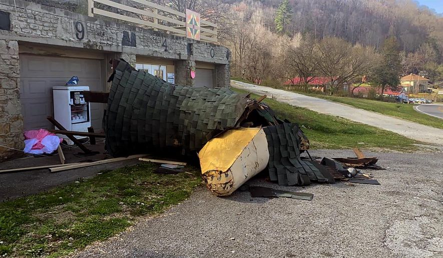Debris covers the ground after part of the Mother Goose house collapsed on March 24, 2021 in Hazard, Ky. The Kentucky town is rallying to help restore the 80-year-old landmark — an oval shaped building that has a domed roof with the neck and head of a goose sticking out the front. Until last week, that is, when the goose was beheaded by strong winds. But community support for the Mother Goose house is pouring in.(Dakota Makres/WYMT via AP)