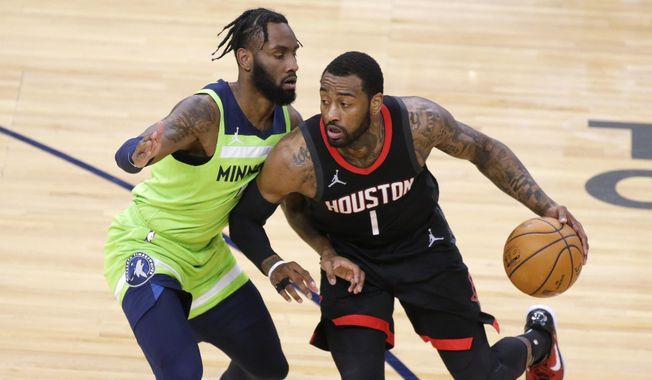 Houston Rockets guard John Wall (1) drives on Minnesota Timberwolves guard Jaylen Nowell (4) during the first half of an NBA basketball game Saturday, March 27, 2021, in Minneapolis. (AP Photo/Andy Clayton-King) **FILE**
