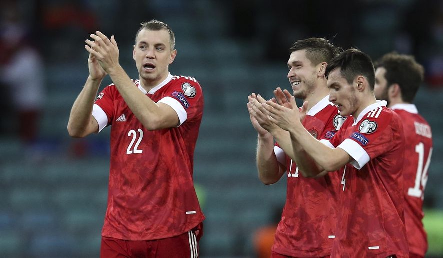 Russia&#39;s Artyom Dzyuba, left, reacts after the World Cup 2022 group H qualifying soccer match between Russia and Slovenia at the Fisht Olympic Stadium in Sochi, Russia, Saturday, March 27, 2021. (AP Photo/str)