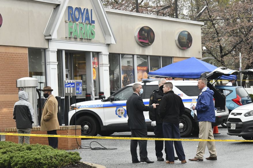 Baltimore County police investigate a shooting Sunday, March 28, 2021 at the Royal Farms in Essex, Md. Police say two people have been killed and a third person injured in a shooting at a Maryland convenience store and gas station. The Baltimore Sun reports that police in Baltimore County were investigating whether the deadly shooting Sunday at a Royal Farms stor was related to a fire and another fatal shooting 15 minutes later at a nearby apartment complex. (Amy Davis/The Baltimore Sun via AP)