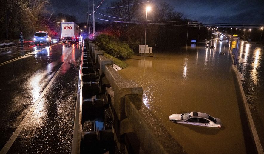 A car is seen submerged on I-24 under Antioch Pike in Nashville, Tenn., Sunday, March 28, 2021. Heavy rain across Tennessee flooded homes and roads early Sunday, prompting officials to rescue numerous people from houses, apartments and vehicles as a line of severe storms crossed the state. (Andrew Nelles/The Tennessean via AP)