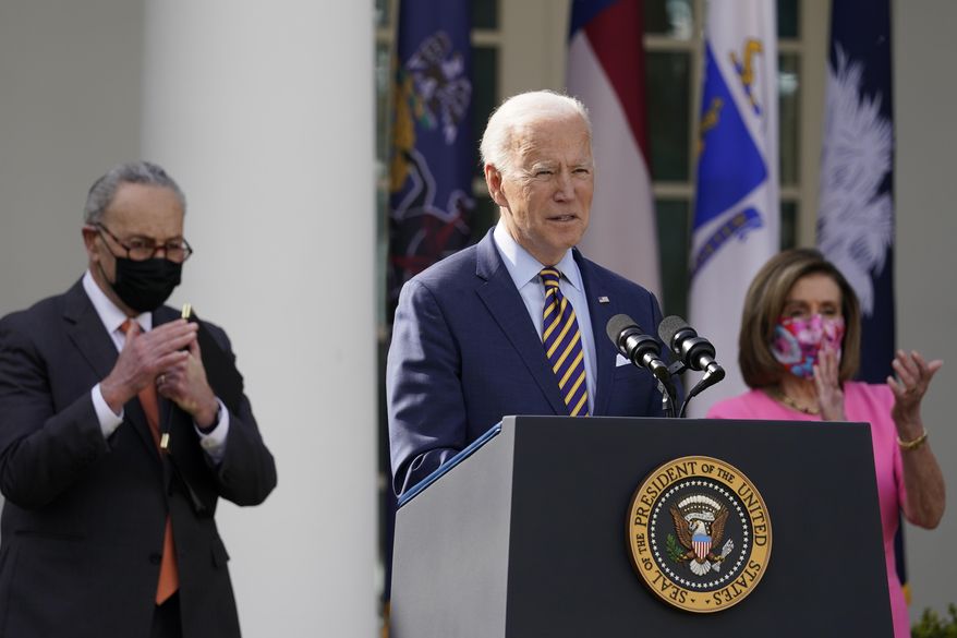 FILE - In this March 12, 2021, file photo President Joe Biden speaks about the American Rescue Plan, a coronavirus relief package, in the Rose Garden of the White House in Washington. Senate Majority Leader Chuck Schumer of N.Y., left, and House Speaker Nancy Pelosi of Calif., listen. (AP Photo/Alex Brandon, File)