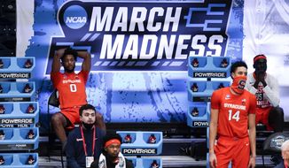 Syracuse forward Alan Griffin (0) and Jesse Edwards (14) watch from the bench against Houston in the second half of a Sweet 16 game in the NCAA men&#39;s college basketball tournament at Hinkle Fieldhouse in Indianapolis, Saturday, March 27, 2021. Houston won 62-46. (AP Photo/Michael Conroy)