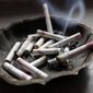 In this Saturday, March 2, 2013 file photo, a cigarette burns in an ashtray in Hayneville, Ala. (AP Photo/Dave Martin)