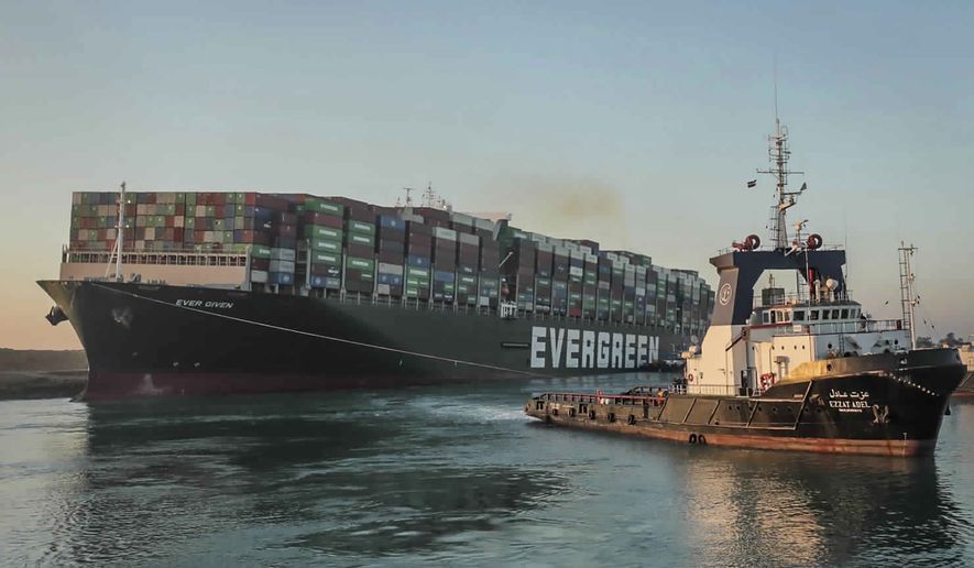 In this photo released by Suez Canal Authority, the Ever Given, a Panama-flagged cargo ship is pulled by one of the Suez Canal tugboats, in the Suez Canal, Egypt, Monday, March 29, 2021. Engineers on Monday &quot;partially refloated &quot; the colossal container ship that continues to block traffic through the Suez Canal, authorities said, without providing further details about when the vessel would be set free. (Suez Canal Authority via AP)