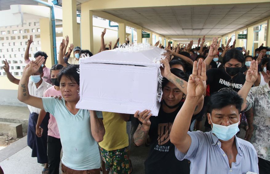 People carry the coffin of a man who was killed during a clash with Myanmar's security forces, during his cremation in Yangon, Myanmar, Monday, March 29, 2021. Over 100 people across the country were killed by security forces on Saturday alone, including several children a toll that has prompted a U.N. human rights expert to accuse the junta of committing mass murder and to criticize the international community for not doing enough to stop it. (AP Photo)