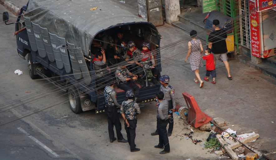 Security forces stand by on Hledan road in Kamayut township of Yangon in Myanmar, Monday, March 29, 2021. Over 100 people across the country were killed by security forces on Saturday alone, including several children. Myanmar aircraft also carried out three strikes along the country's border overnight Sunday, according to a member of the Free Burma Rangers, a humanitarian relief agency that delivers medical and other assistance to villagers. (AP Photo)