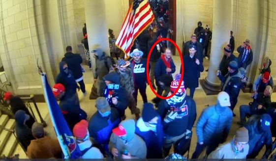 In this image taken from U.S. Capitol Police security camera footage released in a criminal complaint and filed with the U.S. District Court for the District of Columbia, Ethan Seitz, 31, of Bucyrus, Ohio, outlined in red by the source, joins other rioters who stormed the U.S. Capitol on Jan. 6, 2021, in Washington. Seitz was arrested on March 19 on preliminary charges of illegally entering a restricted building, and violent entry and disorderly conduct on Capitol grounds. More than 300 supporters of former President Donald Trump have been charged in the storming of the U.S. Capitol and at least 16 Ohioans are among those charged. (U.S. District Court-District of Columbia via AP)