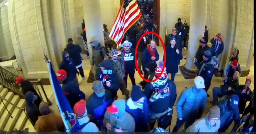 In this image taken from U.S. Capitol Police security camera footage released in a criminal complaint and filed with the U.S. District Court for the District of Columbia, Ethan Seitz, 31, of Bucyrus, Ohio, outlined in red by the source, joins other rioters who stormed the U.S. Capitol on Jan. 6, 2021, in Washington. Seitz was arrested on March 19 on preliminary charges of illegally entering a restricted building, and violent entry and disorderly conduct on Capitol grounds. More than 300 supporters of former President Donald Trump have been charged in the storming of the U.S. Capitol and at least 16 Ohioans are among those charged. (U.S. District Court-District of Columbia via AP)