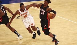 Miami Heat&#39;s Jimmy Butler (22) drives to the basket against New York Knicks&#39; Alec Burks (18) during an NBA basketball game Monday, March 29, 2021, in New York. (Mike Stobe/Pool Photo via AP)