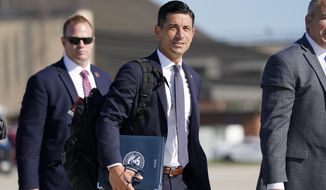 In this Aug. 18, 2020, file photo, then-acting Secretary of Homeland Security Chad Wolf, center, arrives to join President Donald Trump at Andrews Air Force Base in Md. In December, U.S. officials discovered that federal agencies had fallen victim to a cyberespionage effort pulled off largely through a hack of SolarWinds software. (AP Photo/J. Scott Applewhite, File)